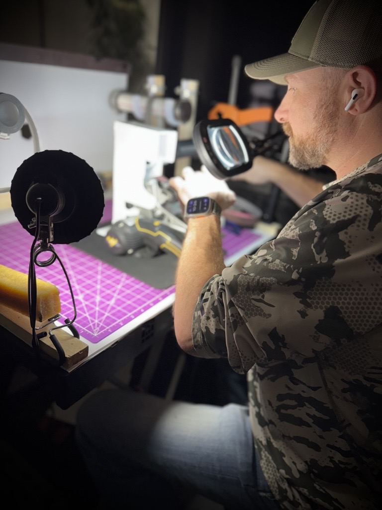 Landon Davis sharpening knife at a workbench — “Blade sharpening in McKinney TX at Texas Blade Revival workshop”